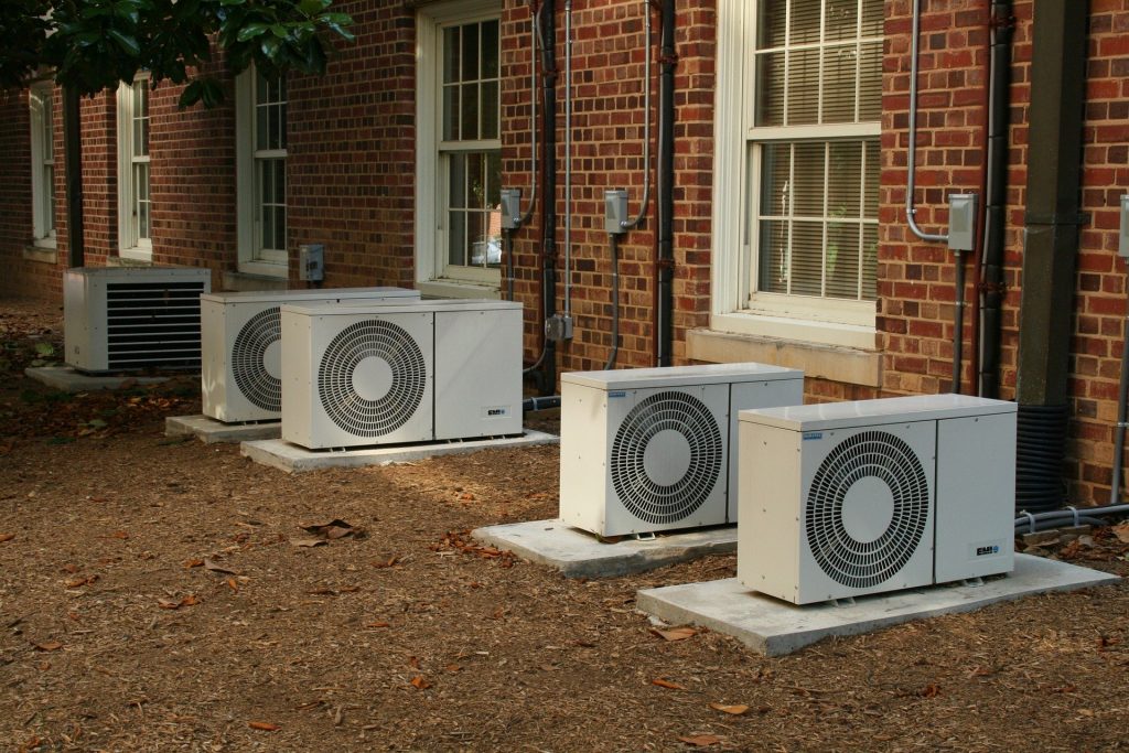 A row of mini split air conditioners used to represent the concept "how to hide your air conditioner unit."