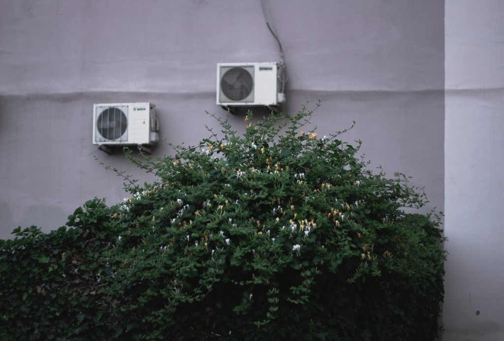 Two air conditioners used to represent the concept "what size air conditioner do I need?"