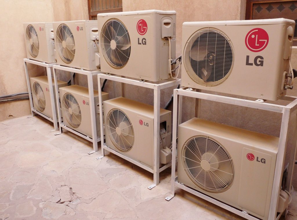 A row of air conditioners used to demonstrate the concept "how often should I have my air conditioner serviced?"