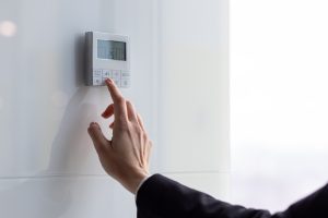 The air conditioning and heating control panel for the apartment and office is located on a white wall