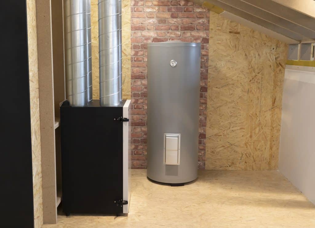 Modern water heater and HVAC ventilation unit installed in a utility room with wood paneling and brick accent wall.