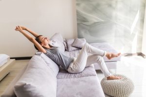 A woman stretching in a clean room, showing air quality in Phoenix you can trust.