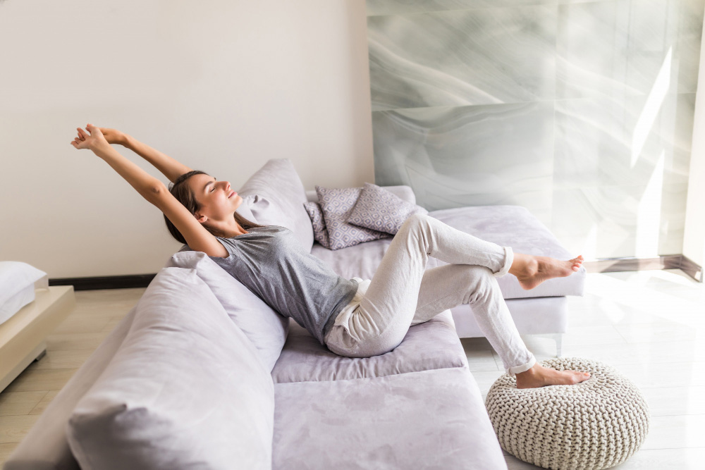 A woman stretching in a clean room, showing air quality in Phoenix you can trust.